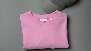 Pink shirt folded with grey hat