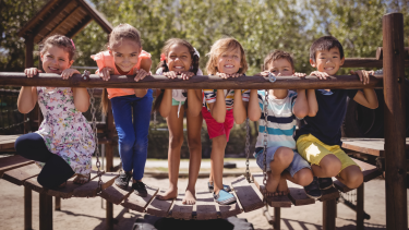 Students on a bridge in a playground