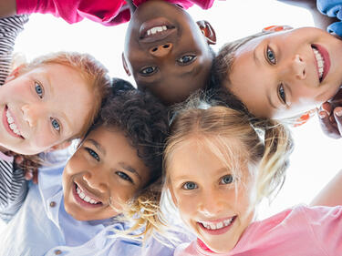 Students gathered looking down at camera