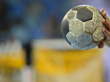 Child holding a handball