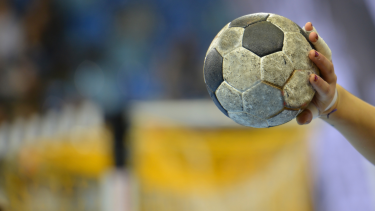 Child holding a handball