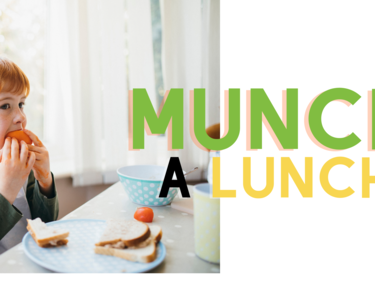 child with red hair eating lunch