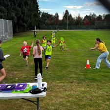 Track and Field students running on the field toward the finish line